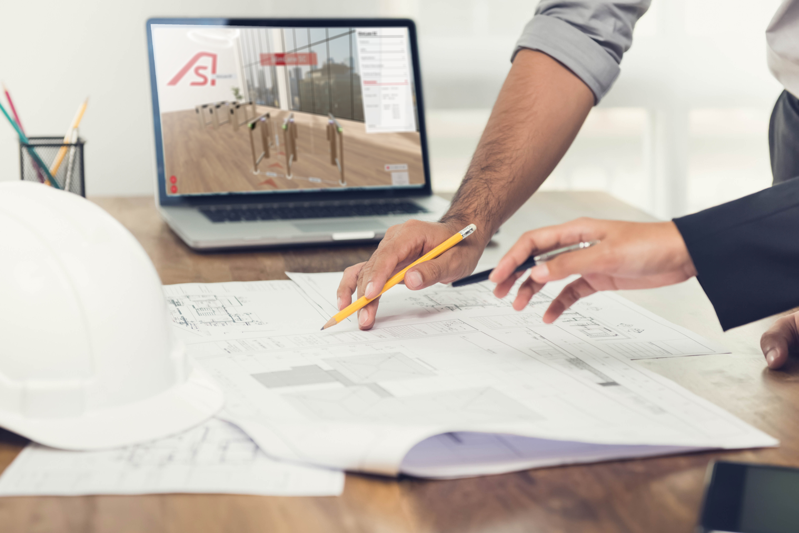 Architect or engineer team discussing a project design using blueprints and a laptop computer at the office before visiting work site.